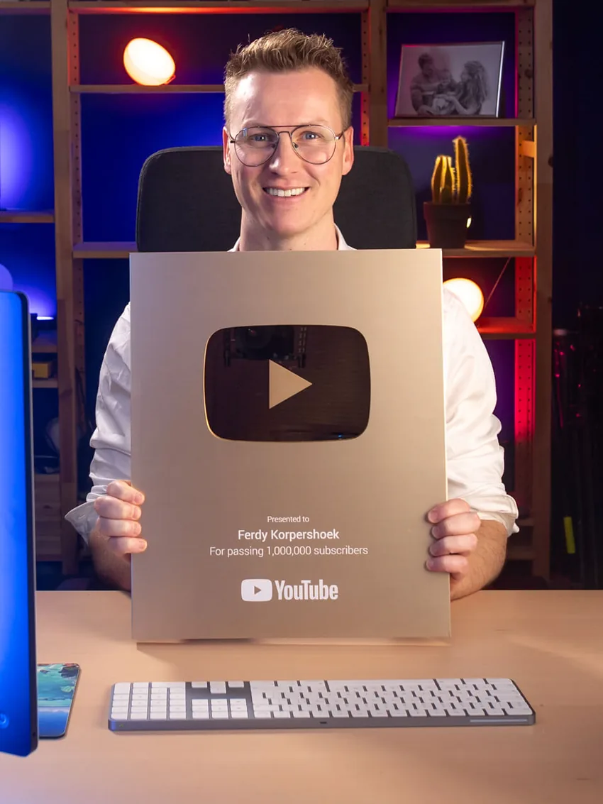 Ferdy holding the YouTube award for passing 1,000,000 subscribers